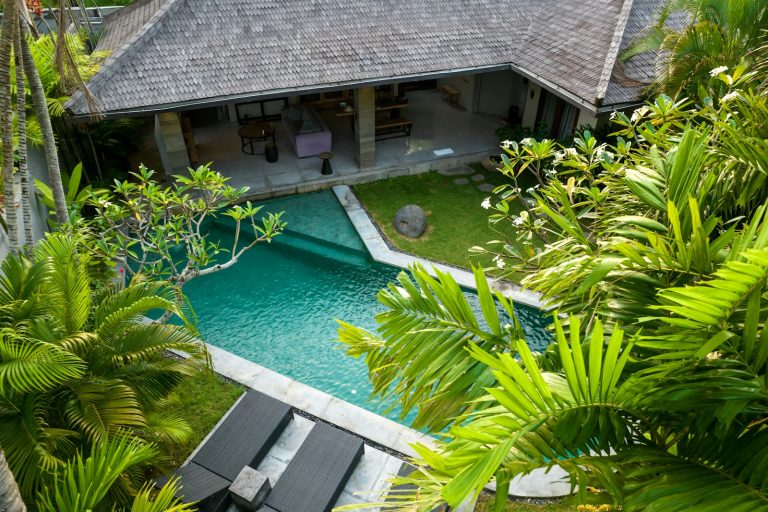 An aerial view of a house with a swimming pool