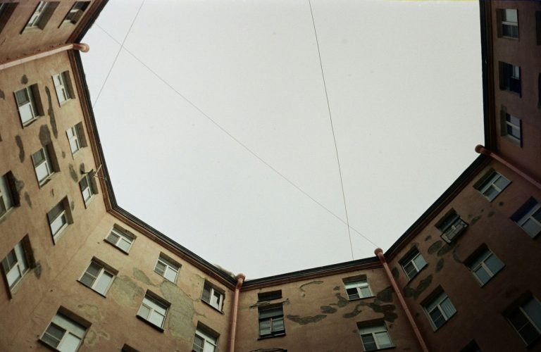 Looking up at a courtyard building with windows