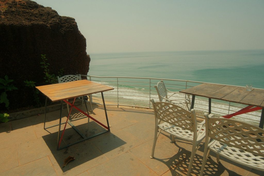 Outdoor tables and chairs overlooking the ocean