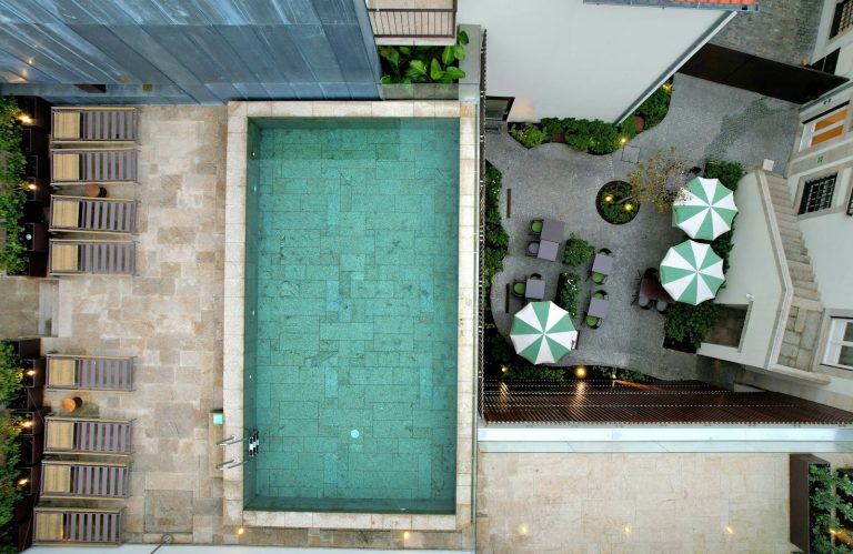 Aerial view of a resort swimming pool and lounge chairs
